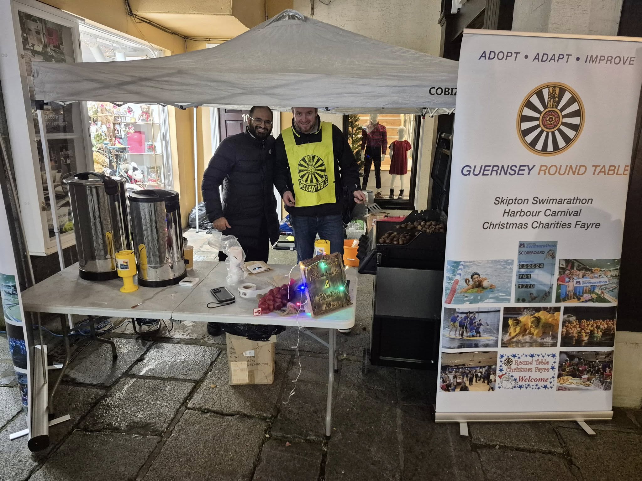 Guernsey Round Table charity stall with the club banner